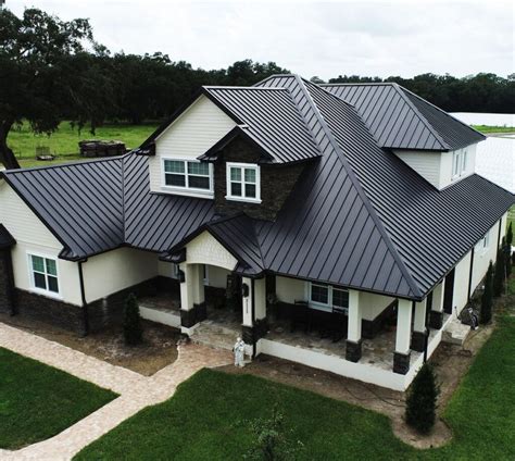 white house with dark grey metal roof|black metal roof house pictures.